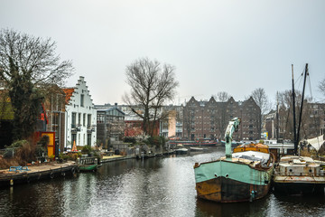 AMSTERDAM, NETHERLANDS - JANUARY 02, 2017: Boats on water in cloudy weather. January 02, 2017 in Amsterdam - Netherland.
