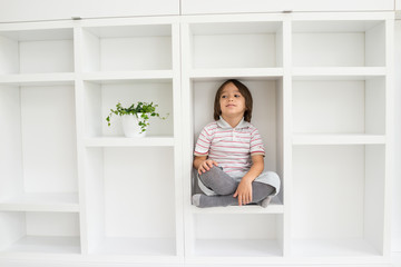 Child in shelf inside living room