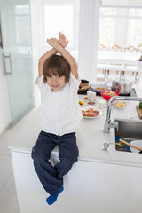 Cute little boy in the modern kitchen