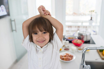 Cute little boy in the modern kitchen