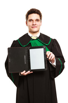 Young male lawyer hold tablet computer.
