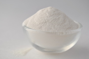 Xanthan gum - a white powder of plant origin for gluten free baking and cooking, closeup on white background
