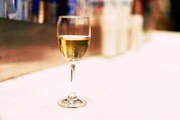 Yellow glass of wine on the table.