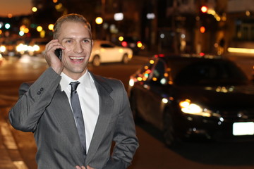 Successful businessman on the phone in the city