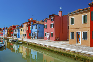 Fototapeta na wymiar Burano island canal, colorful houses and boats, Venice, Italy.