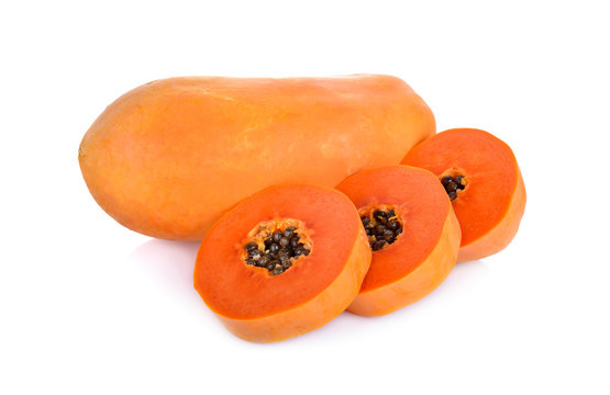 whole and cut ripe papaya on white background