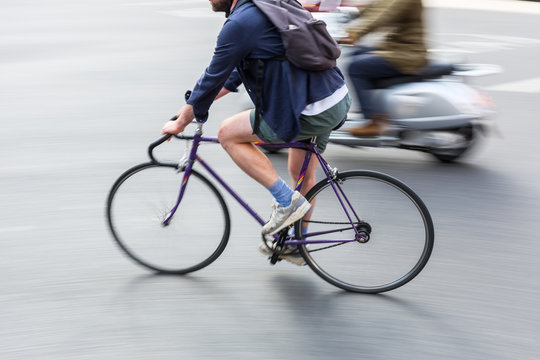 Fototapeta bicycle rider in city traffic in motion blur