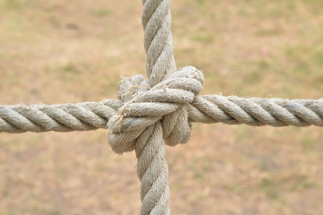 Rope knot line tied together with nature background,as a symbol for trust, teamwork or collaboration