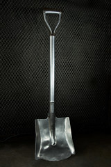 stainless steel shovel on dark background.
