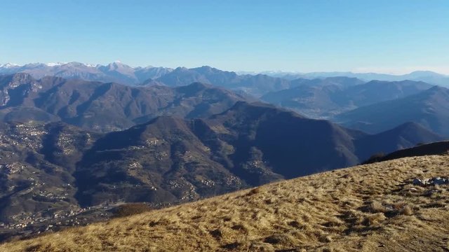 Great landscape with fantastic blue sky on the Orobie Alps and Padana plain a dry winter season without snow. Panorama from Linzone Mountain, Bergamo, Italy. 