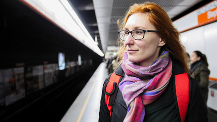 Beautiful young woman waiting subway at underground