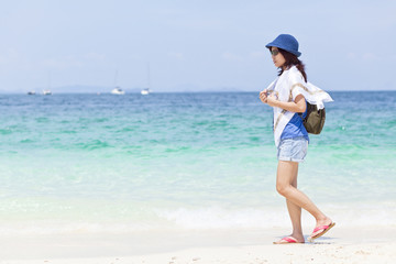 A girl walk and relax on the beach at Phuket island, Thailand