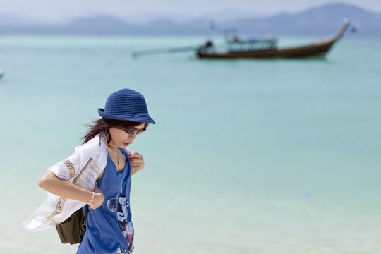 Young woman traveler relax and happy at Phuket beach, Thailand