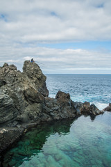 Fisherman at the natural pool Charco De La Laja, at the north of Tenerife, Canary Islands, Spain