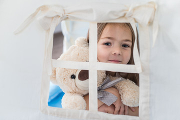 Child playing with a teepee tent
