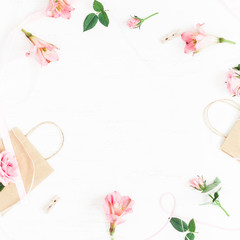 Flowers composition. Gift and rose flowers on white background. Flat lay, top view, square