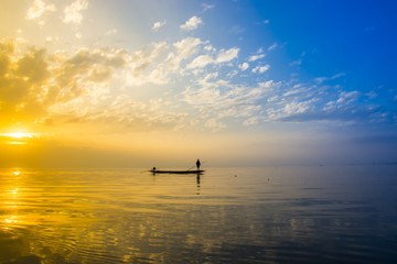 Beautiful sky and Silhouettes of Minimal fisherman at the lake,