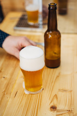 Cold fresh beer in glass with bottle