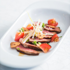  sliced beef with vegetable garnish