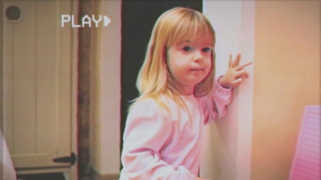 VHS retro fake shot: a cute little girl is amazed at seeing someone in the room. Clip from my Santa Claus Christmas series.
