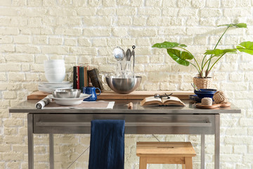 kitchen objects  on the table and brick wall