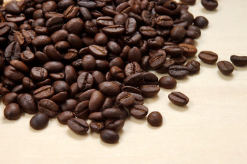 Coffee beans on the wood background.