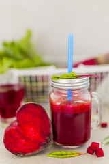 Healthy beetroot smoothie in a mason jar mug on grey stone background. 