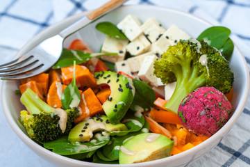 Green vegan salad with broccoli, beetroot and sweet potato falafel.