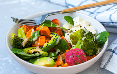 Green vegan salad with broccoli, beetroot and sweet potato falafel.