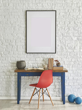blue table and red chair in front of the brick wall