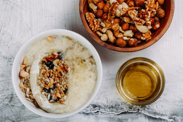 Homemade baked Camembert cheese with garlic, nuts and honey on white background