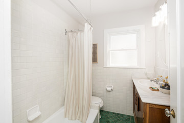 Fototapeta na wymiar Bathroom with green tiles in white