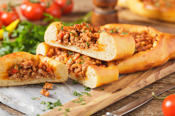 Turkish pide pizza with meat and cheese.