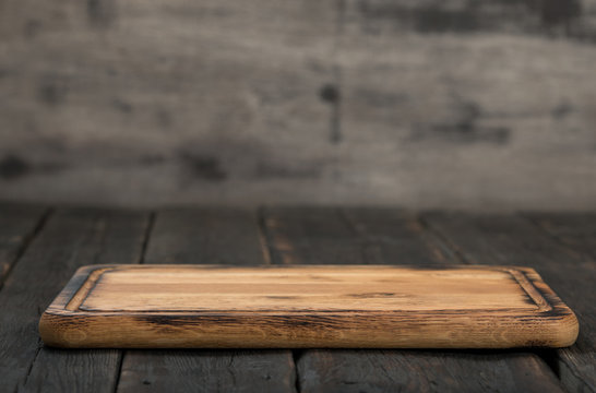 Empty cutting board on a wooden table