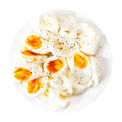 Hard boiled eggs, sliced in halves with black pepper spice  isol