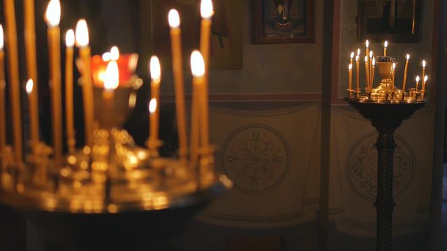 Burning candles in an Orthodox Church. Icons and prayer.