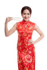 Asian girl in chinese cheongsam dress with  chopsticks.
