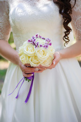 Bride in White Dress Holding Splendid Bridal Boquet Colorful