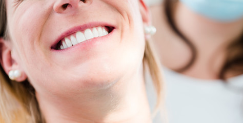 Fototapeta premium Woman with healthy smile at dentist