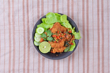 Spicy sour fried chicken salad call Yum Kai Zap - Thai.