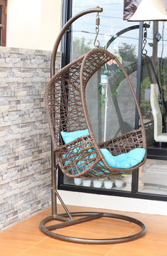 Wicker hanging chair swing hanging on a chain