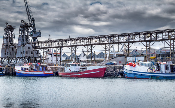 Fishing boats at Cape Town dock on a cloudy day