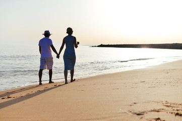 Back view of happy couple on holiday travel vacation beach. Blue sunny ocean sky background