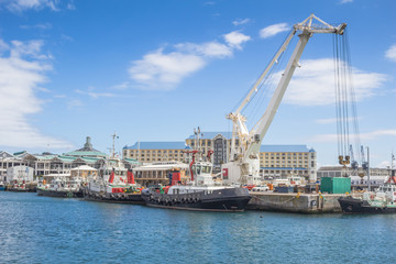 Fototapeta na wymiar Container crane and boats at Victoria and Alfred Waterfront, Cape Town