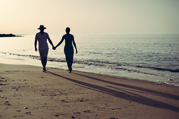 Back view of happy couple on holiday travel vacation beach. Blue sunny ocean sky background
