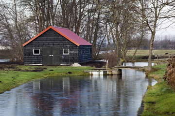 Obraz premium Black barn with a red roof