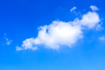 Blue sky background with white clouds on sunny summer or spring day.