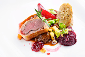 Roast duck, red cabbage roll and dry fruits in fine dining restaurant