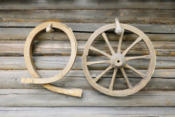 wooden wagon wheel on the wall of the old house