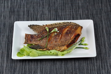 Deep fried little tilapia fish served with spicy bean sauce.